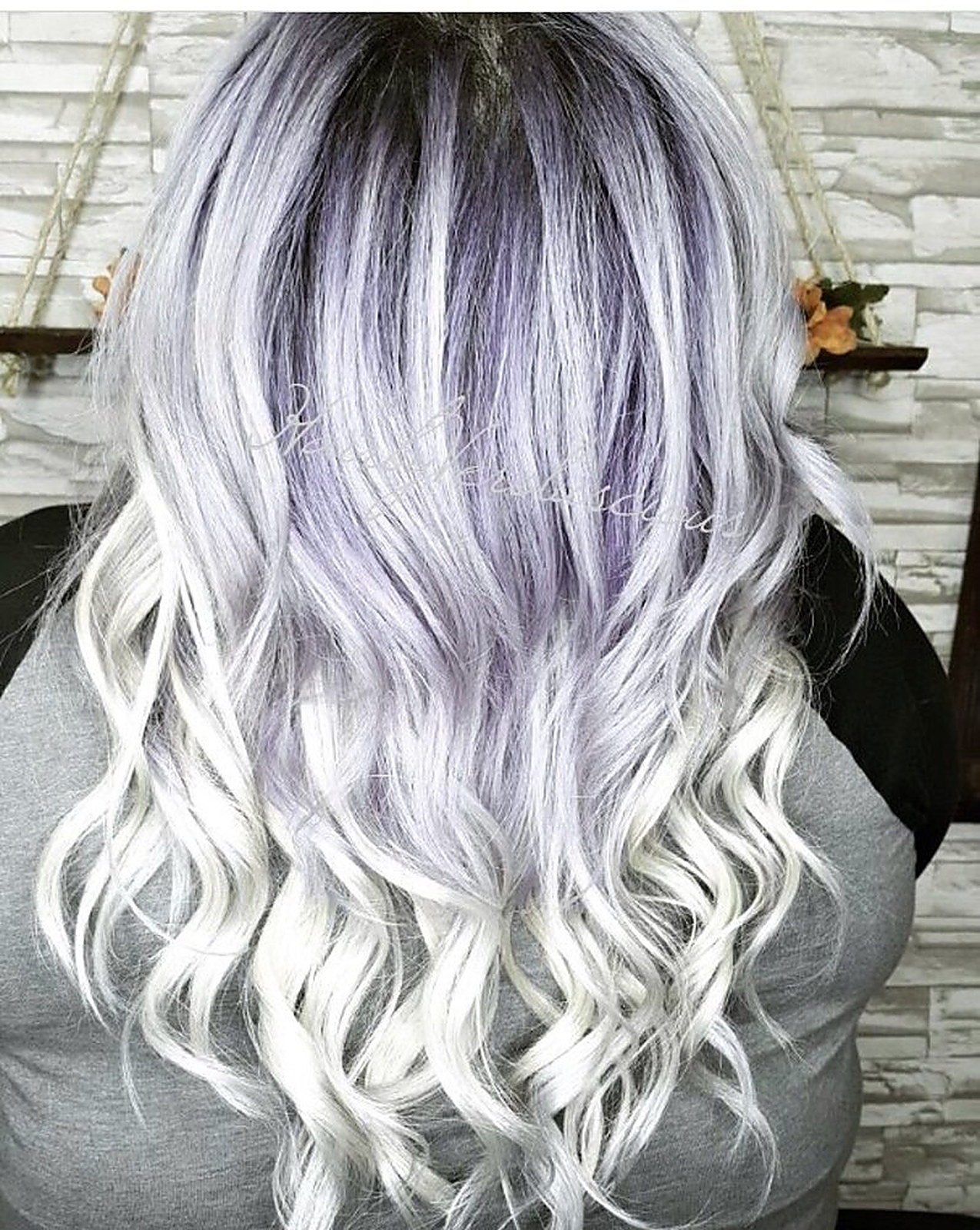 Silver-lilac root melting into white-blonde curls