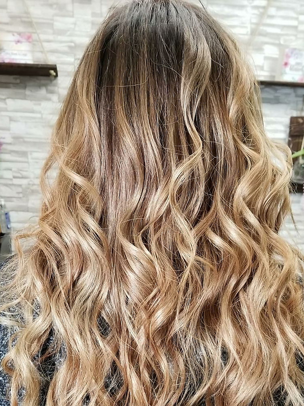 Honey blonde curls with a soft root melt
